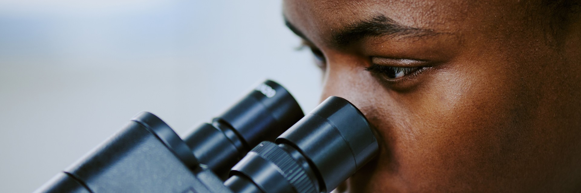 Close-Up of Scientist Using Microscope in Laboratory