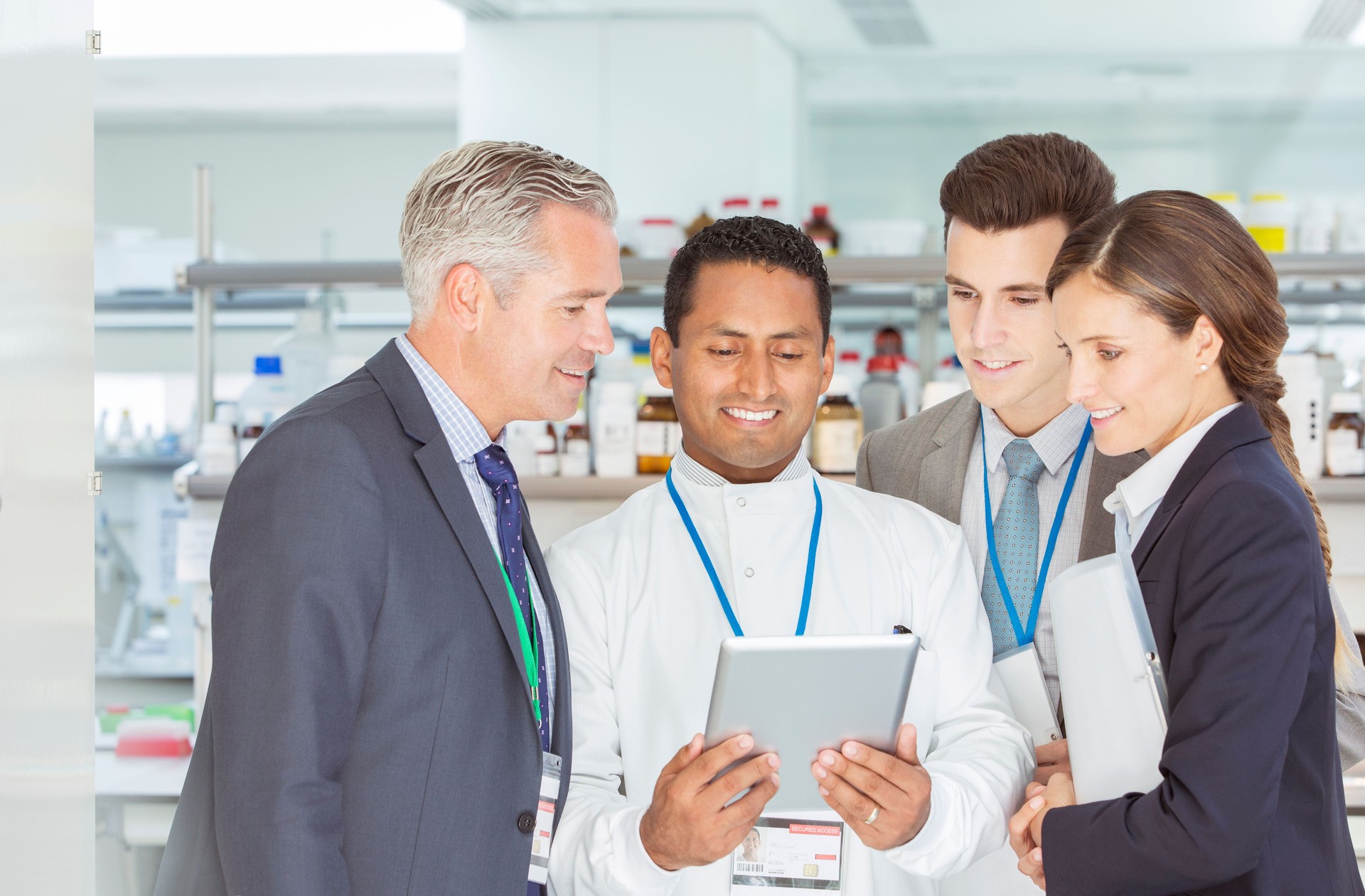 Scientist and business people using digital tablet in laboratory